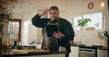 Man, home and tablet in kitchen with confused, doubt or frustrated as entrepreneur. Male person, thinking and tech for tutorial, research or recipe for cooking or meal preparation as private chef