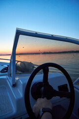 Fototapeta premium the view from the boat on the river and the pink sunset