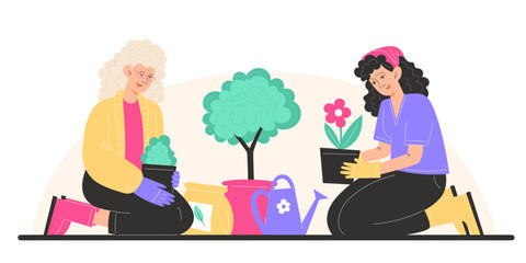 Grandmother and granddaughter plant flowers in pots in the garden