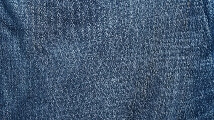 Naklejka premium Close-up textured blue denim fabric background.