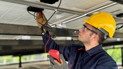 Technical engineer Inspecting the installation of the solar panels and checking the integrity of...