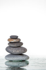 Stack of Smooth Gray Stones on Reflective Surface