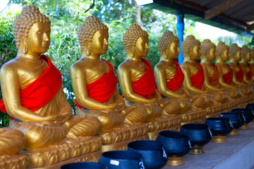 golden Buddha figures in a temple in Phuket, Thailand