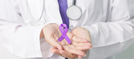 Doctor holding purple Ribbon for Violence, Pancreatic, Esophageal, Testicular cancer, Alzheimer,...