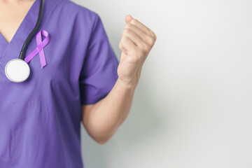 Doctor holding purple Ribbon for Violence, Pancreatic, Esophageal, Testicular cancer, Alzheimer, epilepsy, lupus, Sarcoidosis and Fibromyalgia. Awareness month and World cancer day concept