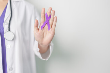 Doctor holding purple Ribbon for Violence, Pancreatic, Esophageal, Testicular cancer, Alzheimer,...
