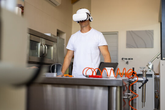 Using VR headset, man working in prosthetic lab with tools on table
