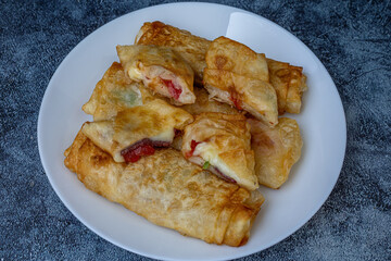Turkish Pacanga Boregi with pastirma (pastrami) and cheddar (melted) cheese. - Pastirmali Borek