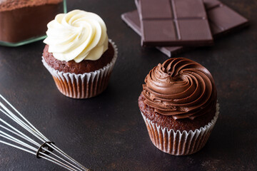 Chocolate cupcakes on brown background. Dessert. Cooking. Baking. Vegetarian food.