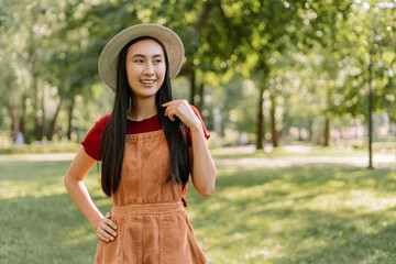 Portrait of asian smiling student looking away in university campus