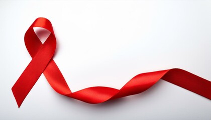 Closeup red ribbon HIV, world AIDS day awareness ribbon on white background. Healthcare and medicine concept.
