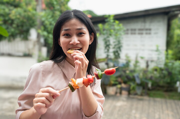 Fototapeta premium Asian woman enjoy eating barbeque