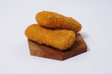 American Risoles or risoles mayo is a traditional Indonesian snack filled with smoked beef or sausage, boiled eggs & mayonnaise. Crispy texture on the outside. Risoles on wood plate isolated white.