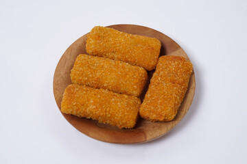 American Risoles or risoles mayo is a traditional Indonesian snack filled with smoked beef or sausage, boiled eggs & mayonnaise. Crispy texture on the outside. Risoles on wood plate isolated white.