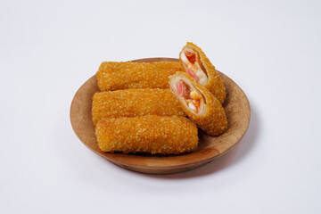 American Risoles or risoles mayo is a traditional Indonesian snack filled with smoked beef or sausage, boiled eggs & mayonnaise. Crispy texture on the outside. Risoles on wood plate isolated white.