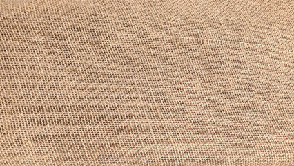 Detailed close-up of natural burlap fabric texture with woven pattern. Close-up shot to reveal texture of sack.