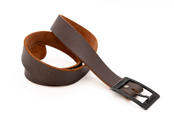 Worn Men's leather belt in a dark brown color with a metal buckle on white background.