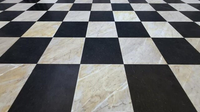 A black and white checkered floor with a white marble tile. The floor is clean and shiny