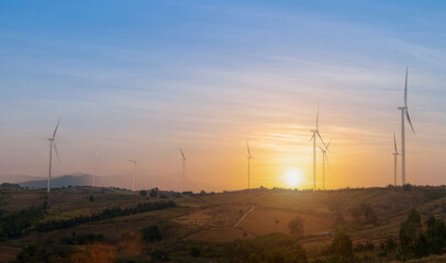 Wind turbine field with blue sky background at sunset. renewable energy