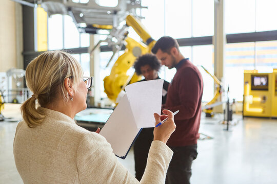 Engineers discussing robotics and automation in modern industrial setting