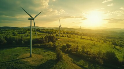 Obraz premium Scenic Landscape with Wind Turbines at Sunset in a Green Field with Rolling Hills and a Golden Sky