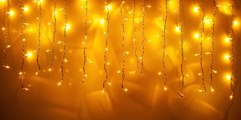 led lights garland on yellow wall with copy space