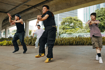 Group of diverse street dancers performing dynamic routine under city bridge with high-energy moves, each dancer expressing unique style, passion, and skill in outdoor urban setting