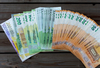 50, 100, 200 and 500 euro bills,  lined up on a wooden table, concept of smuggling, money laundering and fraud