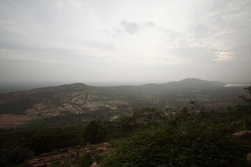 Aerial View of a Vast Landscape, Panoramic View of a Distant Valley, Scenic Landscape at Sunset Time, Misty Mountains and Rolling Hills Stock Photo.