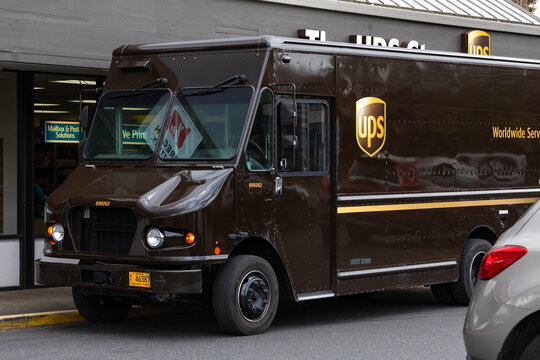 Gresham, OR, USA - April 15, 2024 - United Parcel Service the UPS brown truck parked in front of the UPS store for delivery and shipping