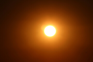 sun in the sky. sunset with flare. sun during sunset.