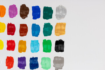 Set with strokes of colorful oil paints on white background, top view