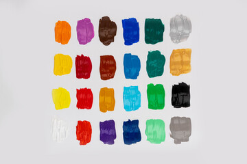 Set with strokes of colorful oil paints on white background, top view