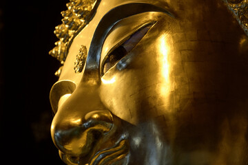 The golden Buddha head has traces of metal plate attachment.