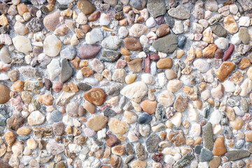 detail of the texture of a floor made of pebbles and concrete, background for construction concept
