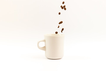 Coffee beans pouring into a cup