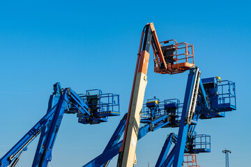 Cluster of boom lifts at a construction site. © Viktor