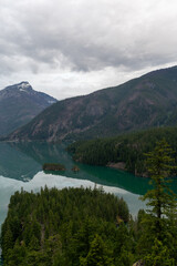 A stunning cloudy morning view of a glacial blue lake in North Cascades.