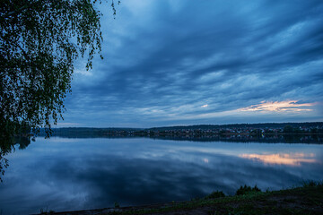 Evening cloudy sky over the lake. Selective focus.