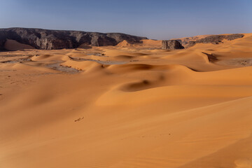 Sahara desert, sand, dunes and rocks in Algeria. Surrounding of Djanet. Place of Sahara named Moul Ennaga