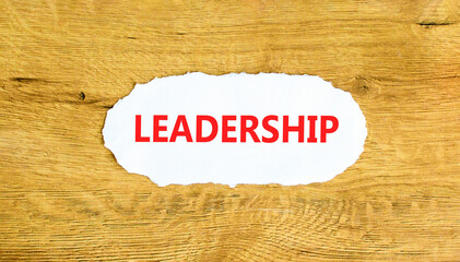 Leadership symbol. Concept word Leadership on beautiful white paper. Beautiful wooden wall...