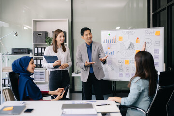 Multiracial group of young creative people in smart casual wear discussing business brainstorming meeting ideas design project.
