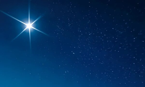 Clear night sky showcasing bright star and numerous fainter stars against gradient blue background