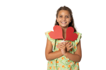 Smiling girl with two carton paper small little heart figures standing isolated over transparent background. Love concept.