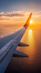 A plane wing is seen with the sun reflecting off the water below