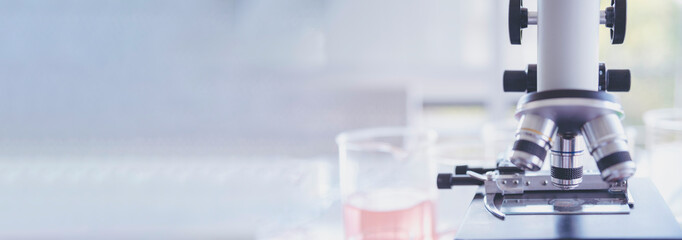 Banner Science microscope equipment in biology chemical laboratory. Scientific experiment Microscope on Lab table microbiology equipment. Banner Chemistry objects on lab background with copy space