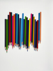 Colorful sharpened pencils are lined up on the table.