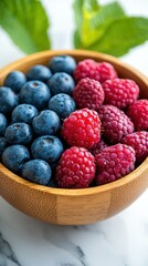 Fresh Blueberries and Raspberries in Wooden Bowl.