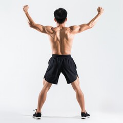 Obraz premium A man with a muscular body is posing with his arms raised in the air