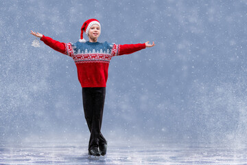 Boy figure skater in Santa Claus hat skating on ice. © Maria Moroz